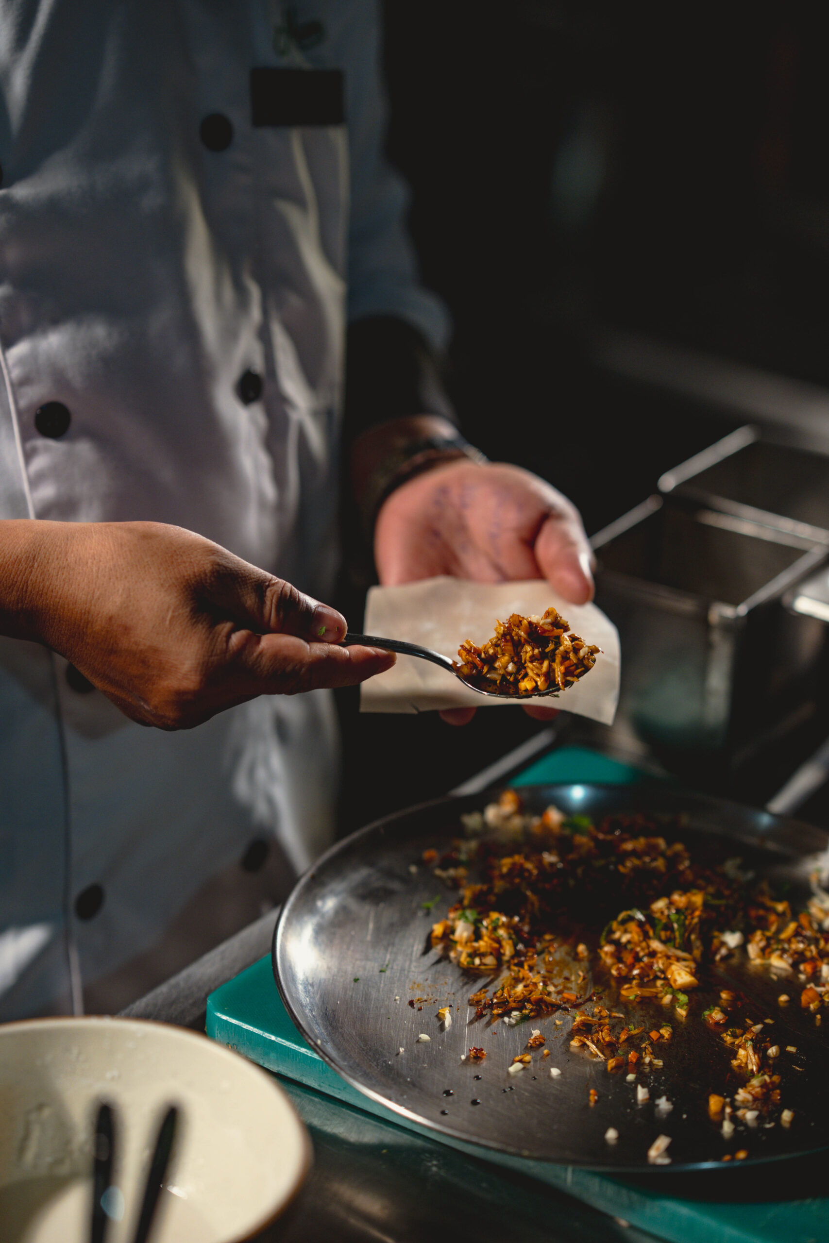 Chef preparing fresh vegetarian appetizer in the kitchen at Agatya Pure Veg Restaurant, showcasing authentic food preparation and quality ingredients in Baner Pune.